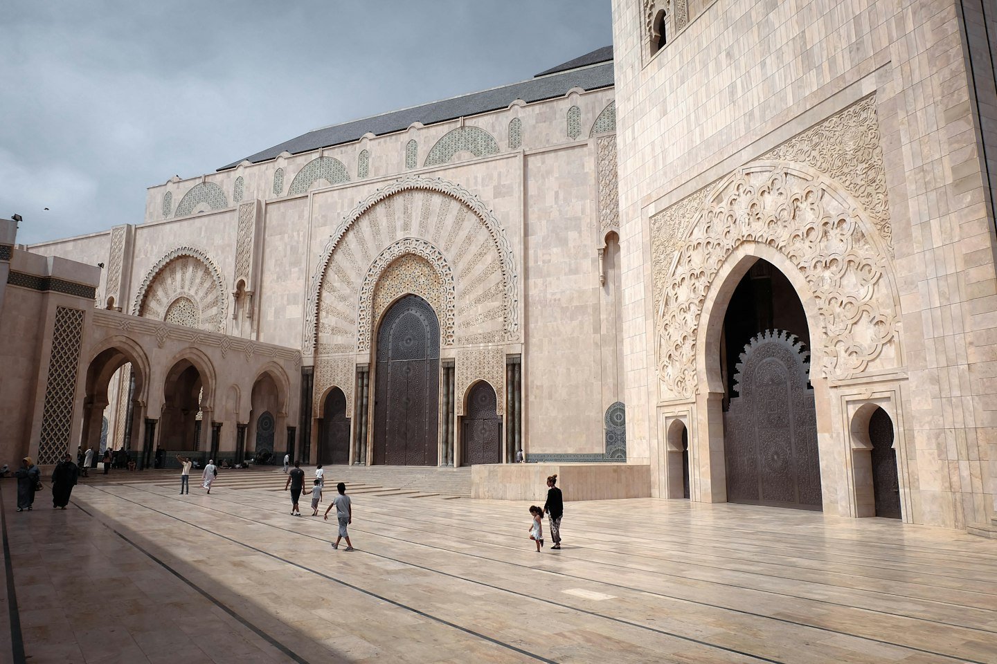An open mosque courtyard with people walking