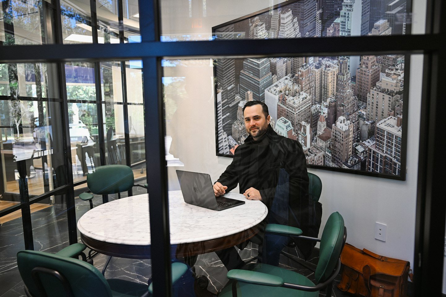 A man working at a laptop in a meeting room